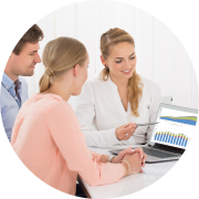 three people looking over a chart on a computer